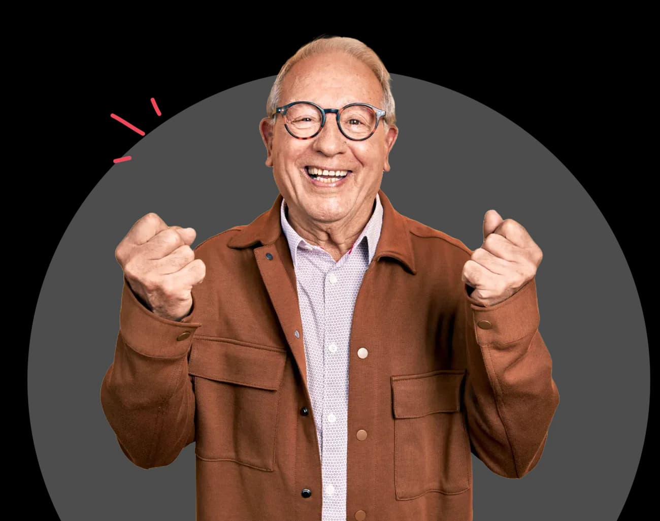 Smiling older man in a brown jacket giving a thumbs up
